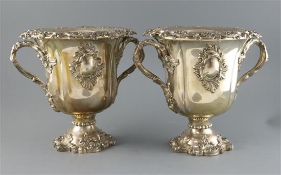 An ornate pair of 19th century Old Sheffield plate two handled pedestal wine coolers, H.26cm